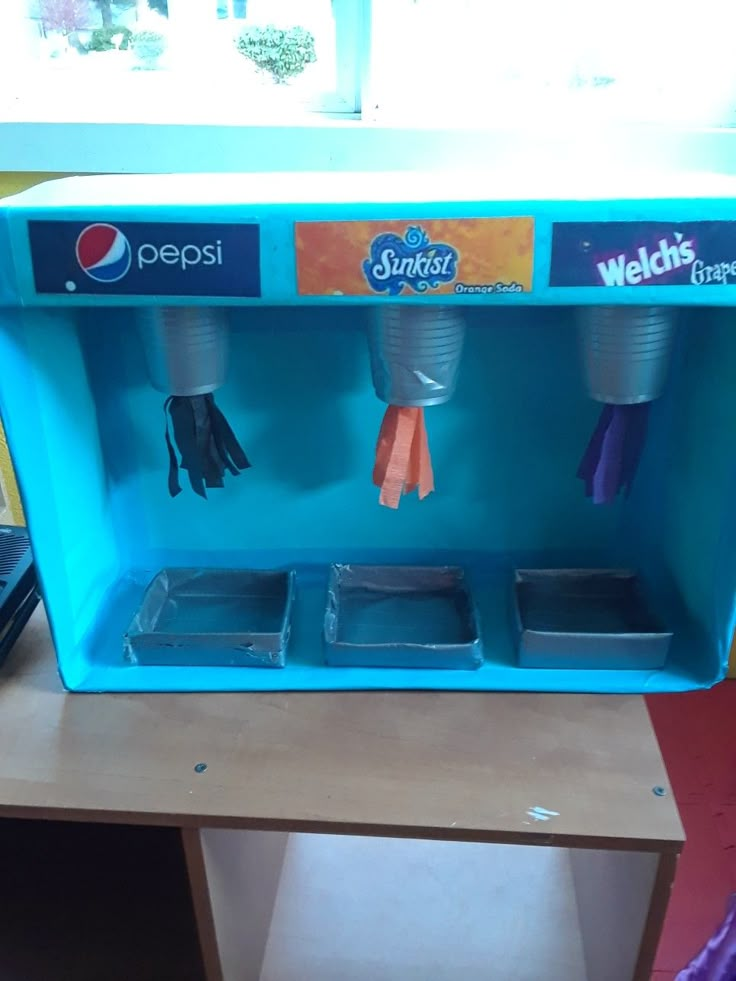 a blue vending machine sitting on top of a wooden table