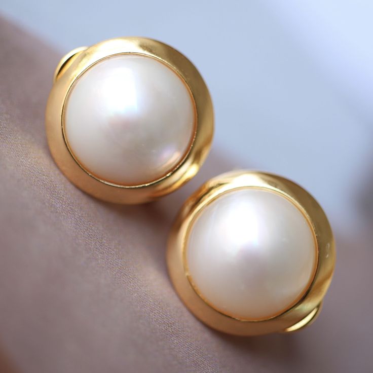 --- SPECIFICS --- 💚Materials: 100% Natural High Quality Mabe Pearl With 24k gold plated s925 Sterling silver 💚-The Mabe Pearl is 100% natural UNTREATED , UNHEATED, UNDYED Mabe Pearl- 💚Metal: Real 24k Gold plated s925 Sterling Silver 💚Pearl Diameter: 12mm*12mm 💚Closure: the closure is made of 925 Sterling Silver.  💚Handmade Artwork, original design and copyright protected💚 These stunning gold plated silver earrings feature a beautiful pair of hemisphere Mabe Pearl stones. With their intric Classic White Gold Clip-on Earrings For Formal Occasions, Elegant Formal Clip-on Earrings, Classic Clip-on Pearl Earrings, Minimalist Hallmarked Earrings For Formal Occasions, Classic Clip-on Earrings For Formal Occasions, Classic Clip-on Earrings For Formal Events, Refined Round Evening Earrings, Classic Clip-on Bridal Earrings For Evening, Classic Evening Bridal Clip-on Earrings