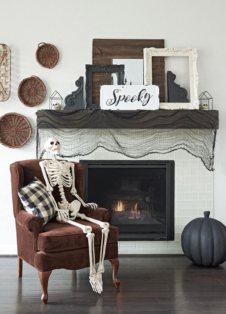 a skeleton sitting on a chair in front of a fireplace