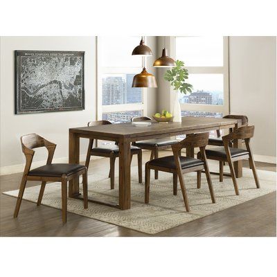 a dining room table and bench in front of a window