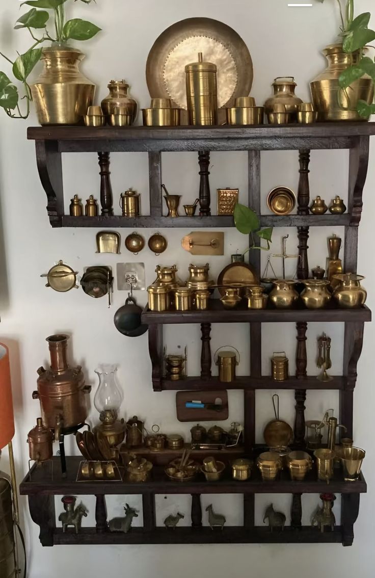 there are many brass items on the shelves