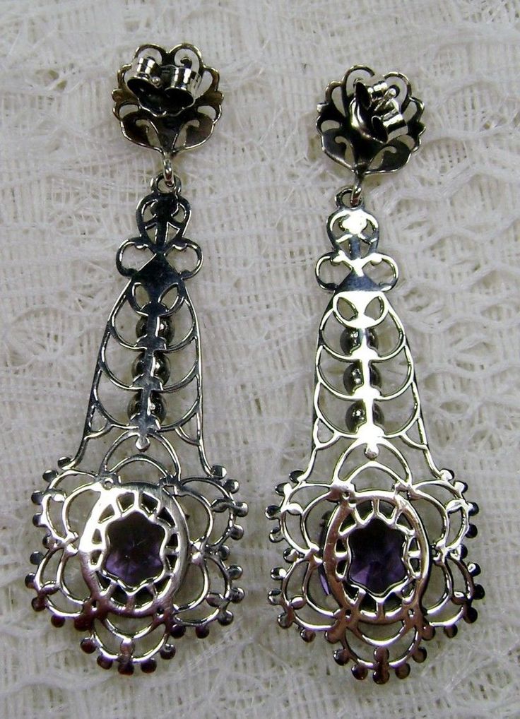 Simulated Purple Amethyst Solid Sterling Silver Earrings Lavaliere Design#E17 Inspired by Victorian era designs, I now offer these lovely Antique estate reproduction earrings in sterling silver (recast from an Antique lavaliere pendant). Each stunning 4 carat flawless Man-made/simulated purple amethyst is 11mm long (just under 1/2") and 9mm in width (3/8"). The lovely amethyst have an excellent light purple color. The earrings are just over 2" inches in length. These earrings are ethereal and cl Ornate Purple Dangle Earrings, Ornate Purple Drop Earrings, Purple Pierced Earrings For Wedding, Ornate Purple Dangle Jewelry, Ornate Purple Jewelry With Matching Earrings, Ornate Purple Pierced Earrings, Purple Earrings With Intricate Design As Gift, Purple Earrings With Intricate Design For Gift, Purple Nickel-free Jewelry For Formal Occasions