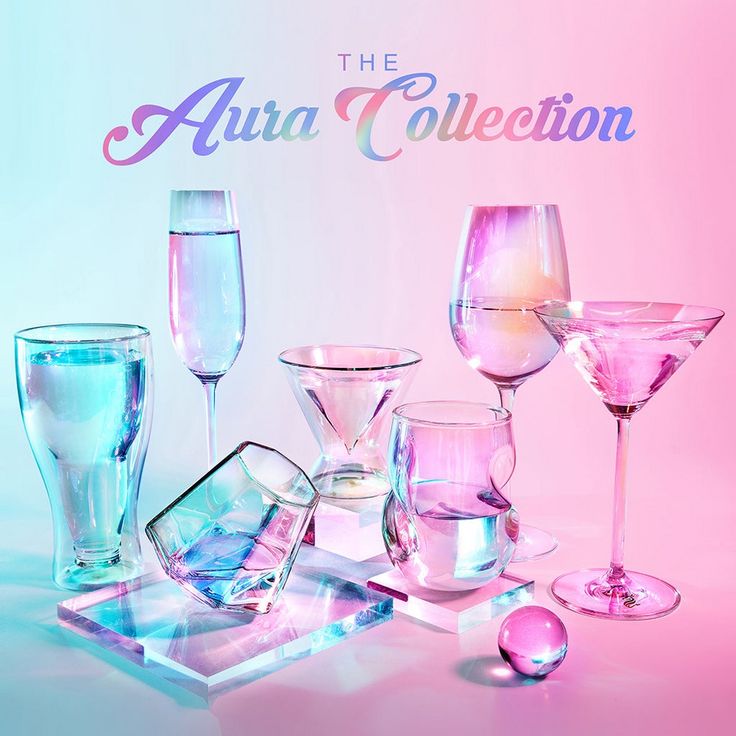 there are many different colored glasses on the table and in front of it is an advertisement for aura collection