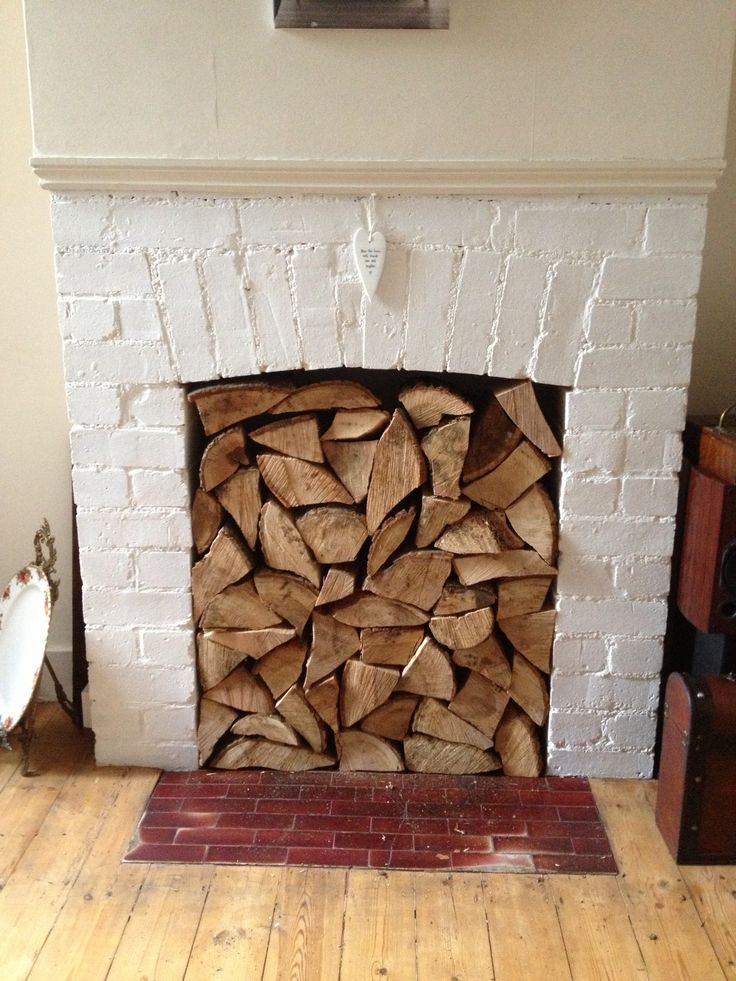 a fire place with logs stacked in it