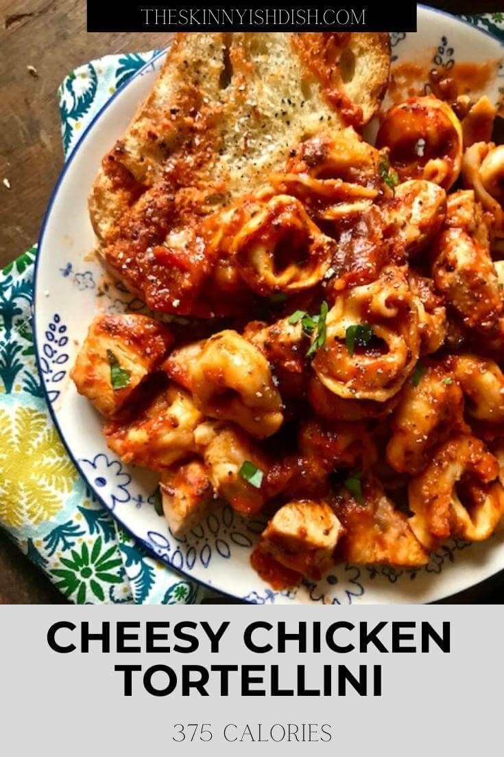 cheesy chicken tortellini on a white plate