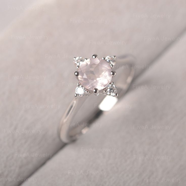 ◆The ring draws inspiration from the polaris. Hand-finished in Sterling sliver, this piece features a round shaped pink quartz. Clear zirzons decorate around the main stone. An extremely simple celestial ring that you cannot miss. ◆ Production Description: Main stone Type: Pink Quartz Main Stone Shape: Round Main Stone Size: 6*6mm Side stone: CZ Metal: 925 Sterling silver - Other options available in the drop down menu ◆ Customization: √Free for Add Engraving √Other Metal Type Available √Other G Dainty Silver Crystal Proposal Ring, Silver Moonstone Promise Ring With Prong Setting, Silver Moonstone Promise Ring In Fine Jewelry Style, Silver 14k White Gold Jewelry For Proposal, 14k White Gold Silver Jewelry For Proposal, Minimalist Sterling Silver Proposal Jewelry, Minimalist Sterling Silver Jewelry For Proposal, Minimalist Silver Jewelry For Proposal, Silver Birthstone Jewelry For Proposal