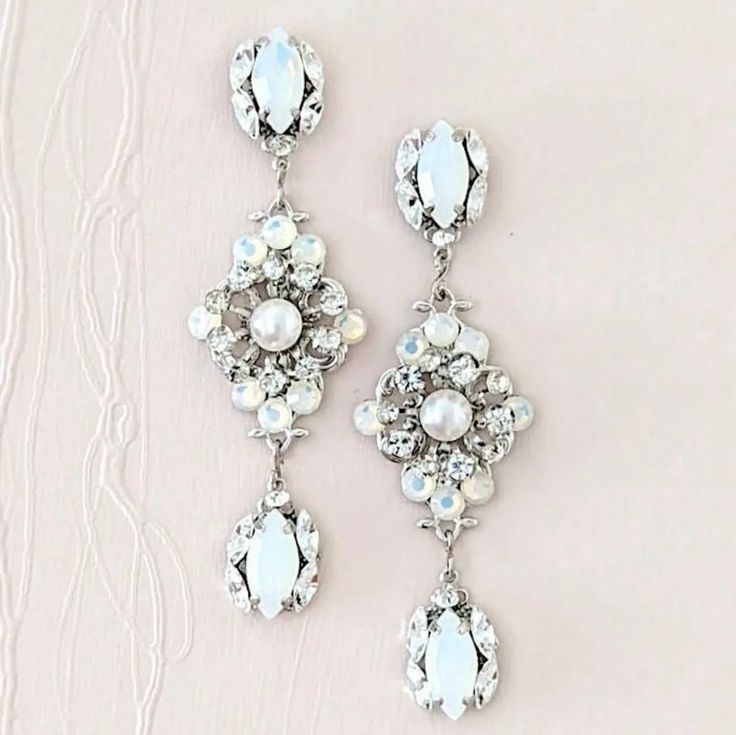 These long bridal earrings are a superb choice for brides who want to add some subtle color with white opal and glam to their wedding... Formal White Chandelier Earrings With Sparkling Stones, Elegant White Bridal Earrings With Sparkling Stones, Elegant White Jewelry For Wedding Reception, Glamorous White Crystal Wedding Earrings, White Chandelier Earrings For Wedding With Sparkling Stones, White Chandelier Earrings With Sparkling Stones For Anniversary, Anniversary White Chandelier Earrings With Sparkling Stones, White Crystal Wedding Earrings With Sparkling Stones, White Bridal Earrings With Sparkling Stones