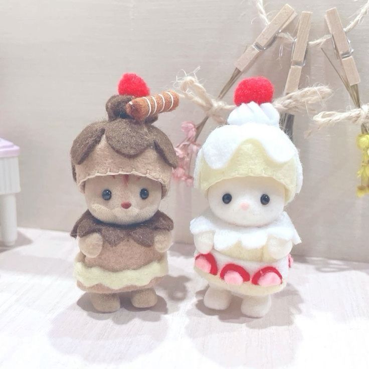 two small stuffed animals are standing next to each other