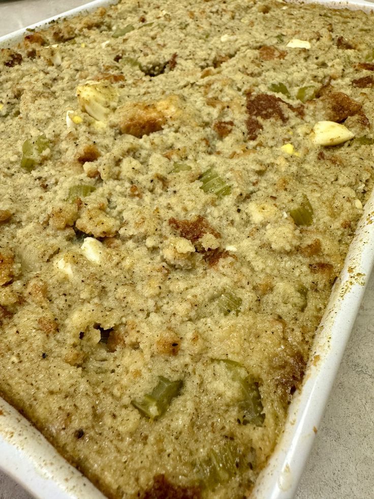 a casserole dish with green beans and other toppings on it sitting on a counter