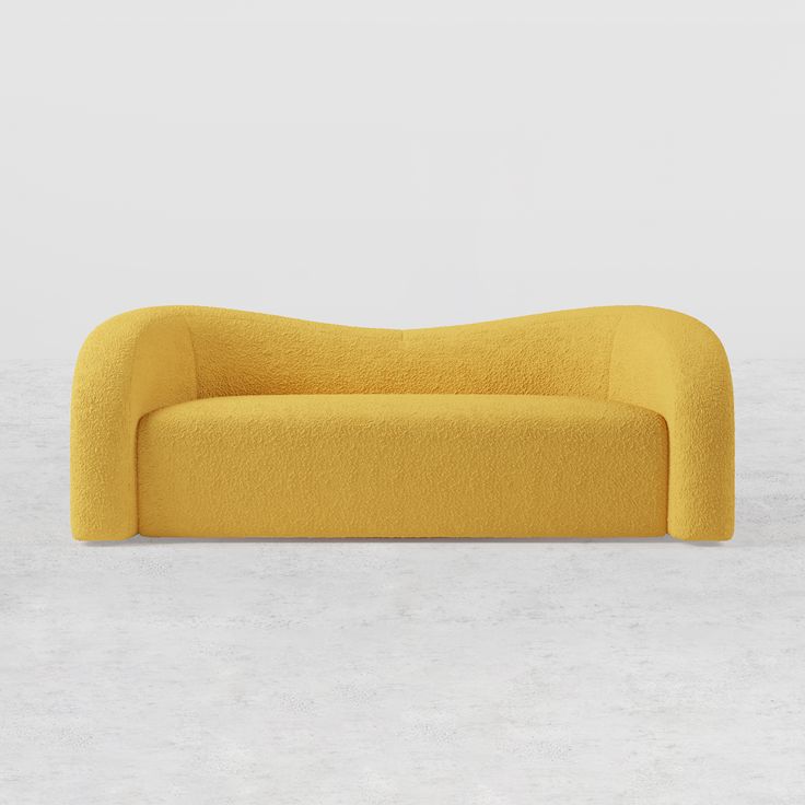 a yellow couch sitting on top of a white floor next to a wall and window