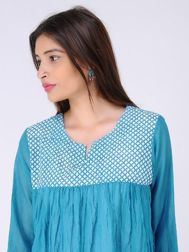 Blue gathered block-printed cambric mul top Garment measurements (in Inches): Size XS : Bust-34", Shoulder-14", Length-30", Sleeve length-17" Size S : Bust-36", Shoulder-14.5", Length-30", Sleeve length-17" Size M : Bust-38", Shoulder-15", Length-30", Sleeve length-17" Size L : Bust-40", Shoulder-15.5", Length-30", Sleeve length-17" Size XL : Bust-42", Shoulder-16", Length-30", Sleeve length-17" Size XXL : Bust-44", Shoulder-16.5", Length-30", Sleeve length-17" Size 3XL : Bust-46", Shoulder-17", Spring Anarkali Top With Long Sleeves, Spring Anarkali Long Sleeve Tops, Anarkali Style Straight Kurta Top With Printed Motifs, Blue Bandhani Print Kurta For Summer, Blue Bohemian Blouse With Printed Motifs, Bohemian Blue Blouse With Printed Motifs, Cotton Kurta With Yoke For Navratri, Navratri Cotton Kurta With Yoke Detail, Festive Blue Anarkali Top