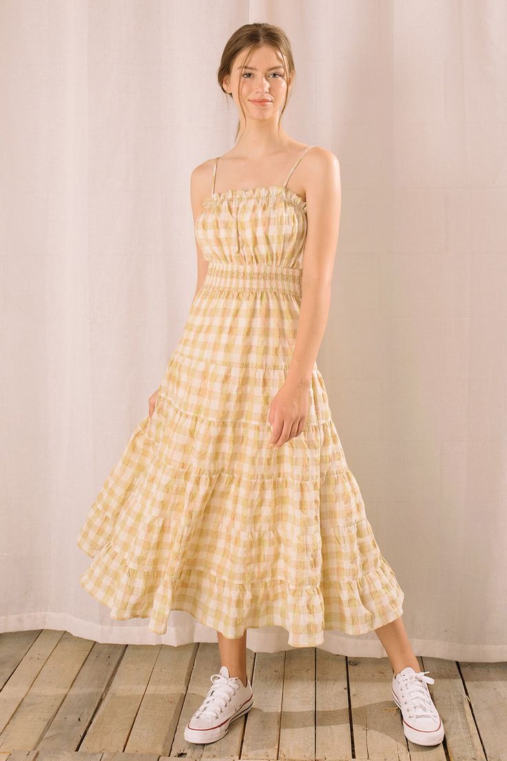 It features a straight elastic gathered neckline with ruffle trim around it and a smocked cinched high waist. It also has adjustable spaghetti straps and a ruffled flowy maxi bottom. Material:Cotton Yellow Gingham Dress, Poofy Sleeves, Emma Style, Gathered Neckline, Sun Dresses, Spaghetti Strap Maxi Dress, Check Fabric, Yellow Plaid, Gingham Dress