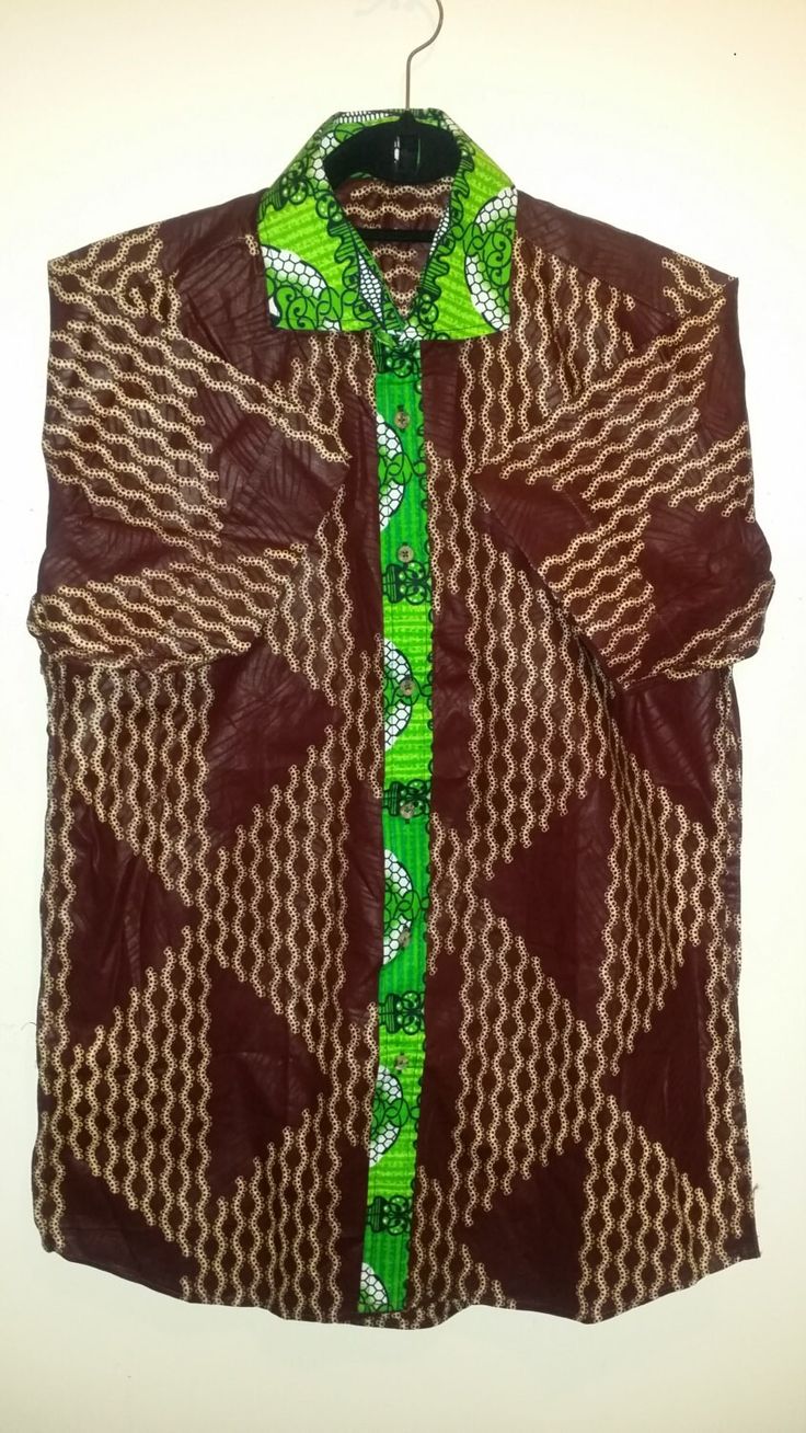 "Short-sleeved shirt covered with cool yet vibrant Ankara print. Tailored with a classic fit for casual wear. Basic collar, front buttons Ankara (African) Wax Print  29.5\" full length, 42-44\" Chest, 9\" sleeve length  Machine wash cold / dry clean  Made in USA" Fitted Long Sleeve Tops With Traditional Patterns, Casual Red Long Sleeve Kaftan, Red Long Sleeve Casual Kaftan, Casual Printed Green Kaftan, Casual Green Printed Kaftan, Multicolor Long Sleeve Tops With Traditional Patterns, Fitted Multicolor Short Sleeve Kaftan, Casual Long Sleeve Top With Traditional Patterns, Patterned Short Sleeve Printed Kaftan