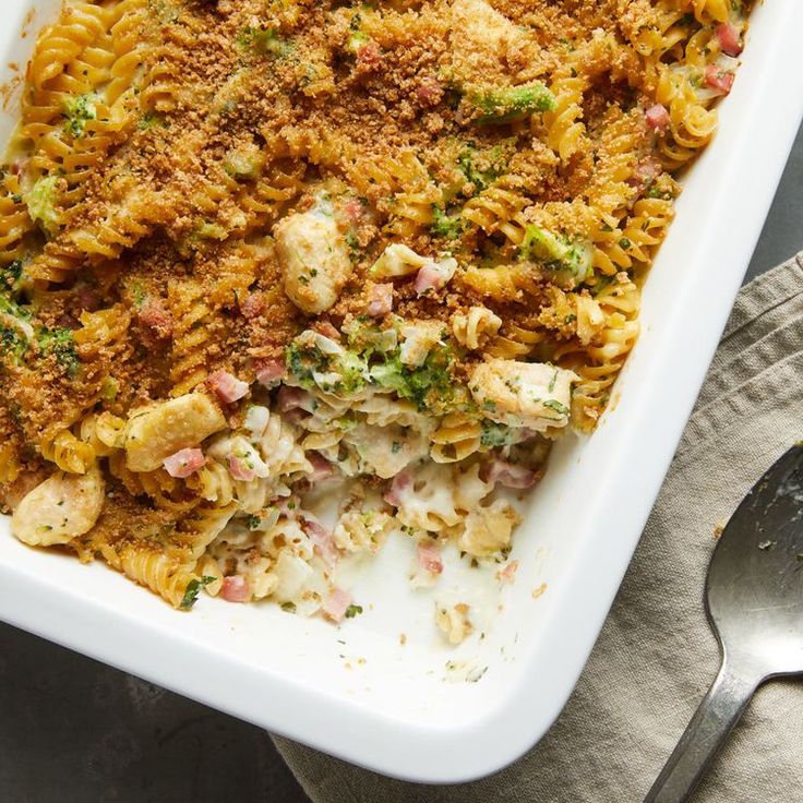 a casserole dish filled with pasta, meat and veggie toppings