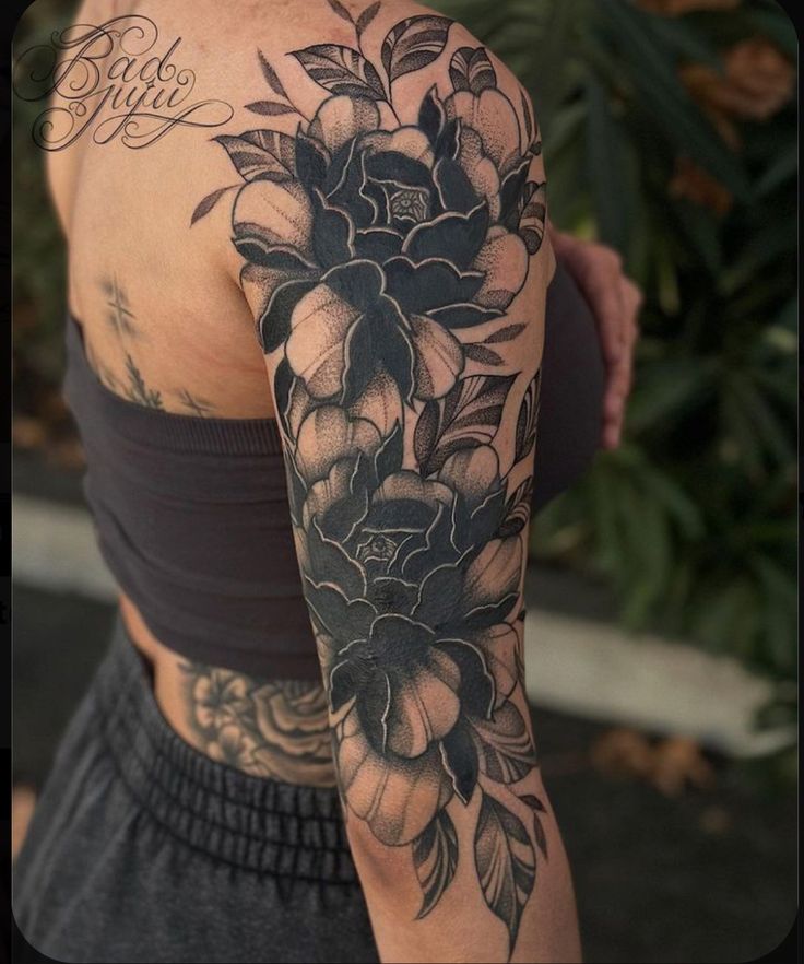 a woman's arm with flowers on it