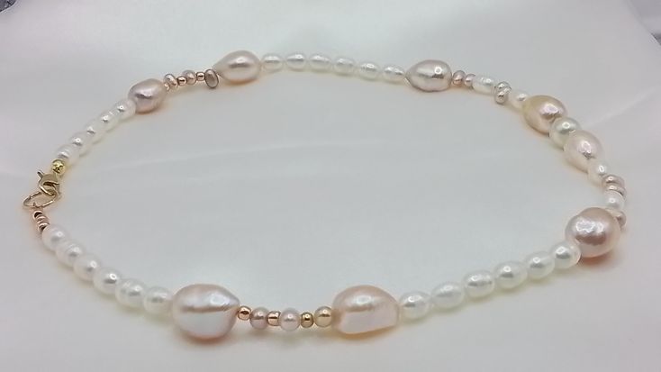 Pretty pink and white mixed pearls  necklace.  Large pink baroque pearls shown with white rice pearls and small Dainty pink  pearls. A lovely mix of quality natural freshwaterpearls. A beautiful gift for your wife girlfriend sweetheart or just a new addition to your jewelry box. This necklace will be a staple for your feminine outfits. Ready to dispatch to you with free shipping and my handmade items are one of a kind....special and distinctive.  Thanks for visiting GemsbyZoey... Handmade Pearl White Baroque Pearl Necklace, Pink Pearl Necklace For Gift, Pink Round Beads Pearl Necklace For Gift, Pink Pearl Necklace With Round Beads For Gift, Pink Pearl Charm Necklace For Wedding, Wedding Pink Pearl Charm Necklace, Elegant Pink Pear-shaped Necklace, Handmade Pink Pearl Necklace, Handmade Baroque Pearl Necklace In Pear Shape