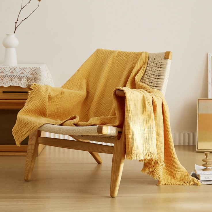 a chair with a yellow blanket on it