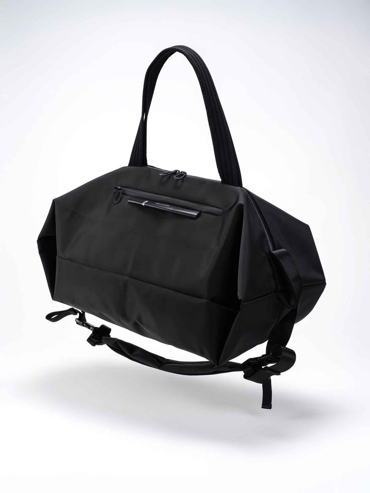 The SANNA is the ideal travel companion for those who are planning a multi-day trip and require both adequate storage space and comfort. Taking on the form of a duffle bag, the SANNA can be carried in a number of ways, either using the shoulder strap or carry handles. Black buckles on the exterior are used to hold the shoulder straps in place when they are not in use. Rectangular Nylon Satchel For On-the-go, Functional Top Handle Satchel For On-the-go, Large Capacity Nylon Satchel For On-the-go, Versatile On-the-go Backpack Duffle Bag, Sporty Rectangular Shoulder Bag For Travel, Rectangular Duffle Bag With Large Capacity For On-the-go, Nylon Top Handle Bag For On-the-go, Nylon Top Handle On-the-go Bag, On-the-go Nylon Top Handle Bag