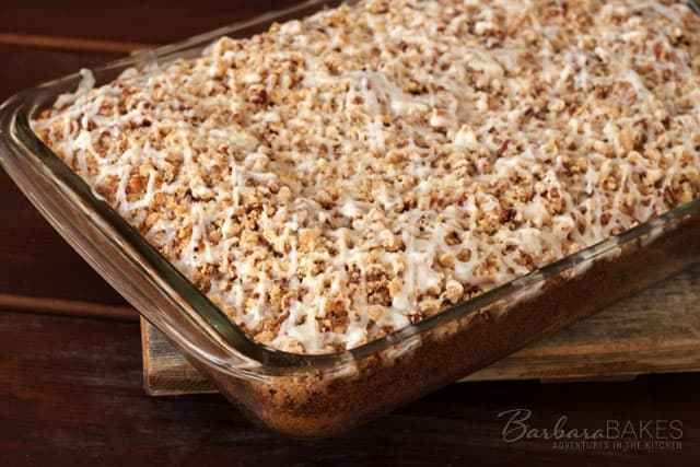 a casserole dish filled with food sitting on top of a wooden cutting board