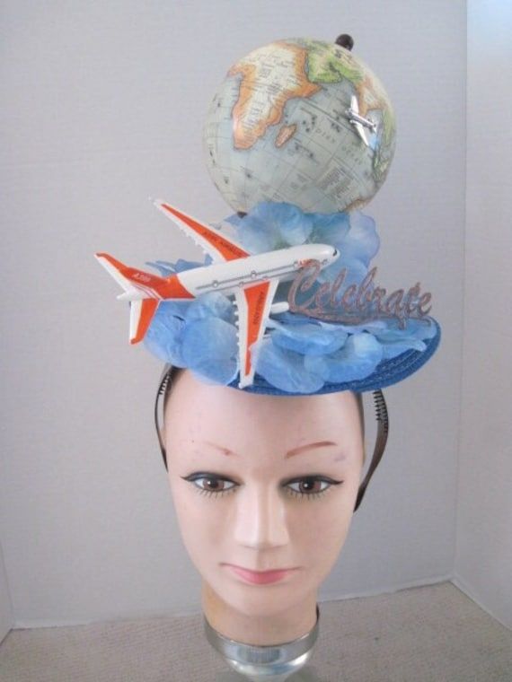 *  Great for that special party to celebrate a once in a life time flight to travel to your dream vacation.  Wear to that party or be presented with this fascinator and then wear later to entice visitors to ask about your adventures. *  This piece sits directly on top of the head and has a world globe with an airplane flying around it.  A larger acrylic plane sits at the base with a gold Celebrate sign. *  On a wide sturdy acrylic headband it is secure, well balanced and comfortable to wear. * Cardboard Airplane, Wilbur Wright, Acrylic Headband, Pilot Hat, Crazy Hat, Planes Party, Easter Hat, Airplane Flying, Funky Hats