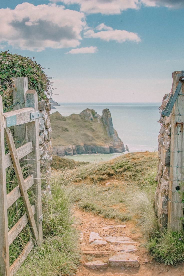 an old wooden gate leading to the ocean