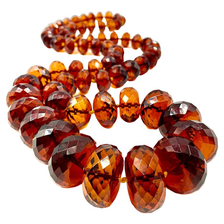 Superb, rare natural translucent faceted Baltic amber necklace of impressive size, gem quality and color reminiscent of fine rich cognac. This necklace has been tested for natural amber and has a high degree of electrical attraction. The reddish orange, vermillion color is scarcely seen in natural amber necklaces of this scale. Amber has long been associated with the power of attraction and excellent communication, as is the color red- making this necklace doubly desirable. 38.5 inches (97.8cm) Luxury Orange Gemstone Beads Jewelry, Luxury Amber Natural Stones, Luxury Orange Gemstone Beaded Necklaces, Unique Luxury Orange Necklaces, Luxury Citrine Amber Necklace, Luxury Gold Plated Amber Jewelry, Luxury Amber Oval Beads Jewelry, Cheap Amber Necklaces, Luxury Gold Baltic Amber Necklace