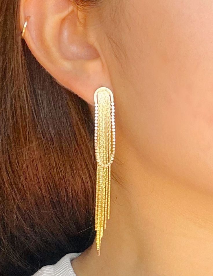 Add an elegant touch to your look with these exquisite tassel drop earrings. The intricate gold and rhodium plating add a luxurious shine to these statement earrings, making them perfect for any occasion. Elevate your style with these exclusive and sophisticated earrings. Made in Colombia. Luxury Tassel Dangle Earrings, Luxury Tassel Dangle Earrings For Party, Luxury Tassel Drop Earrings For Parties, Luxury Elegant Dangle Tassel Earrings, Luxury Women's Drop Tassel Earrings, Luxury Elegant Tassel Dangle Earrings, Luxury Tassel Wedding Jewelry, Luxury Elegant Tassel Earrings For Parties, Luxury Tassel Jewelry For Wedding