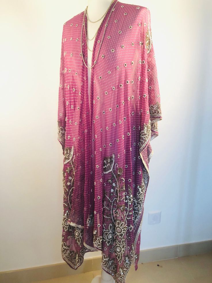 "A Unique and Truly Beautiful Kimono Jacket. This has been Handmade from a Vintage Indian Silk Sari.... so is completely Original and one of a kind. A Wonderfully Chic, flattering colour way of Dusky Lilac,Embellished with allover Beads and Sequins that Sparkle and catch the Light. The Gorgeous embroidery design has 1000's of Silver bugle beads , Pearly white beads and Glittering Crystals. This Stunning 3/4 length Jacket is made in Silk Chiffon ,so drapes elegantly ,with loose Waterfall sleeves Traditional Silk Sequin Kaftan, Traditional Silk Kaftan With Sequins, Bollywood Sequin Kaftan For Festivals, Traditional Sequined Kaftan With Drape, Traditional Sequined Kaftan With Traditional Drape, Pink Kaftan For Party Festivals, Traditional Festive Sequined Kaftan, Pink Kaftan For Party And Festivals, Party Pink Kaftan With Mirror Work