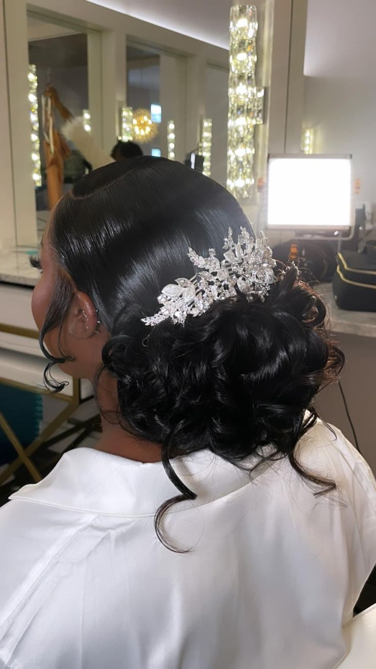 the back of a woman's head wearing a bridal hair comb in a salon