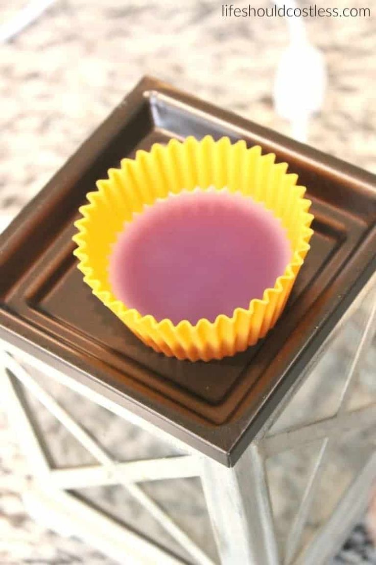 a yellow cupcake liner sitting on top of a metal tray in front of a mirror