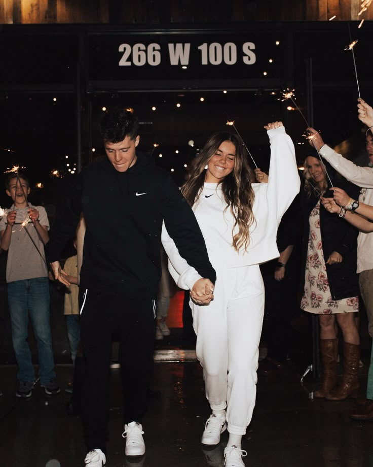 a man and woman holding sparklers in their hands