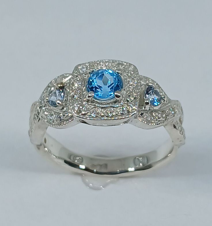 This stunning  style ring has been carefully crafted in 925 solid sterling silver (not silver plated), blue  topaz stone and cubic zirconia.  This beautiful ring would make a great special occasion/birthday gift All of my jewelry is handmade from scratch and of high quality. A tracking shipping number will be provided to you once ring has been mailed. Ring Measurements: Ring is size 7 1/2 but can be resized at no extra cost and will be shipped to you in an elegant gift box. Ring Weight: 3.7 gram Blue Topaz Ring In 14k White Gold, Blue Cubic Zirconia Promise Ring, Fine Jewelry For Anniversary In Light Blue, Silver Topaz Birthstone Ring In Fine Jewelry Style, Blue Cubic Zirconia Promise Jewelry, Fine Jewelry Topaz With Halo Design, Blue Diamond Birthstone Ring For Promise, Blue Diamond Birthstone Promise Ring, Dazzling Sterling Silver Topaz Ring For Anniversary