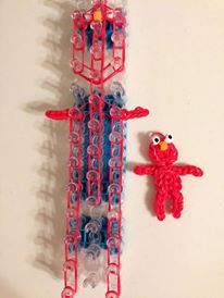 two red and blue plastic toys on a white surface with one toy in the shape of a bird