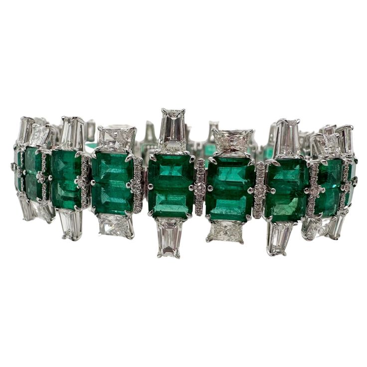 Rare matching emerald and diamond bracelet in 18KT whte gold. The bracelet is made in Art Deco style, creator is known. The matching emeralds are Colombian origin and are a beautiful bluish green color, the bracelet is made with a rare exquisite craftsmanship and excellent matching stones! Metal Type: 18KT Gram Weight:34.39 grams Natural Emerald(s): Color: Bluish Green Cut:Emerald Carat: 23.90ct Clarity: Slightly Included Origin: Colombia Natural Diamond(s): Color: F-G Cut:Round Brilliant, Emera Luxury Emerald Cut Green Diamond Bracelet, Luxury Art Deco Women's Bracelets, Emerald Art Deco, Luxury Emerald-cut Diamond Bracelet With Accents, Luxury Vintage Green Cuff Bracelet, Colombian Emerald Necklace, Emerald Art, Bracelet Tennis, Art Deco Bracelet