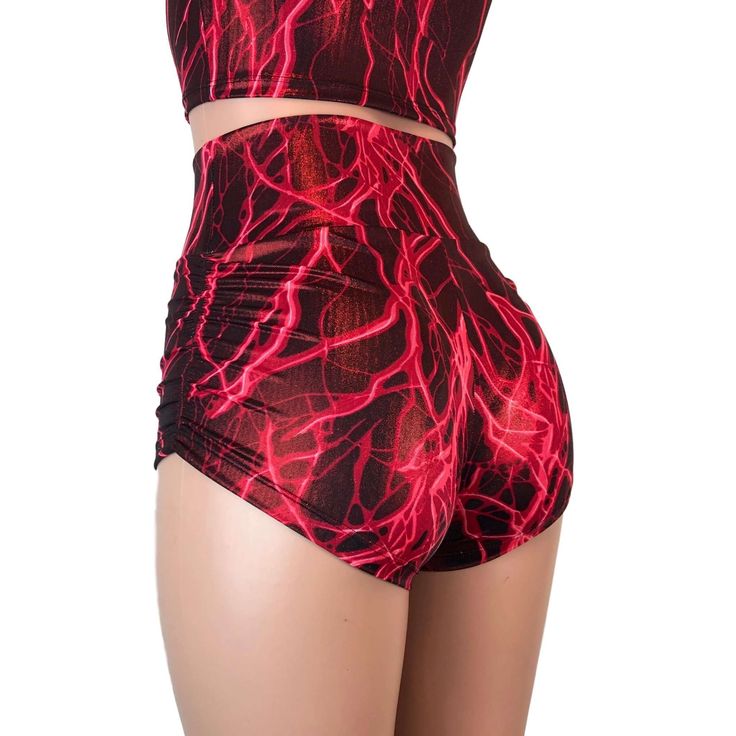 Sexier and more flattering! Our classic booty shorts made in red lightning metallic spandex with ruching on each side. Made to flatter your figure and move with you. This amazing fabric has red lightning streaks (looks amazing under a blacklight) with a gold metallic sheen. These shorts are popular for pole fitness and aerial performers. The standard inseam is 2.5" Stretch Red Biker Shorts For Gym, Red Stretch Biker Shorts For Gym, Red Stretch Gym Shorts, Fitted Red Athletic Shorts For Gym, High Waist Red Bottoms For Club, Red Fitted Athletic Shorts For Sports, Fitted Red Athletic Shorts For Sports, High Stretch Red Party Bottoms, High Stretch Red Bottoms For Party