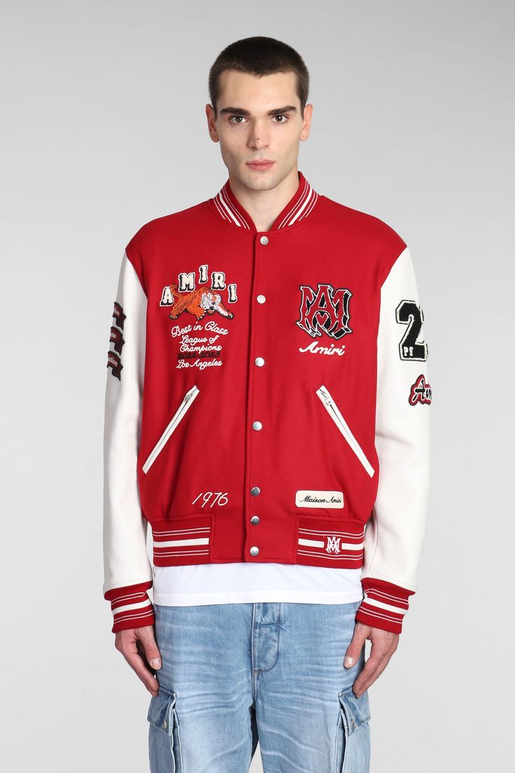 a man wearing a red and white jacket with patches on it