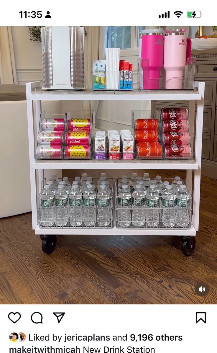 a white cart filled with lots of bottles and cans on top of a hard wood floor