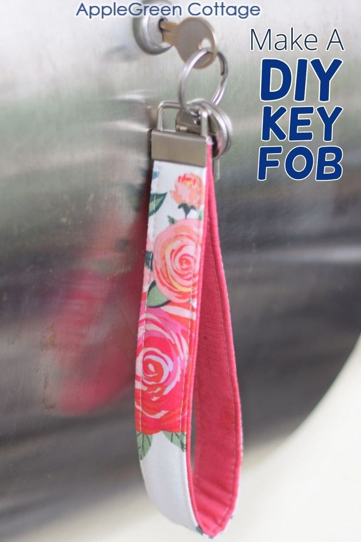 the key fob is hanging from the side of a metal container with flowers on it