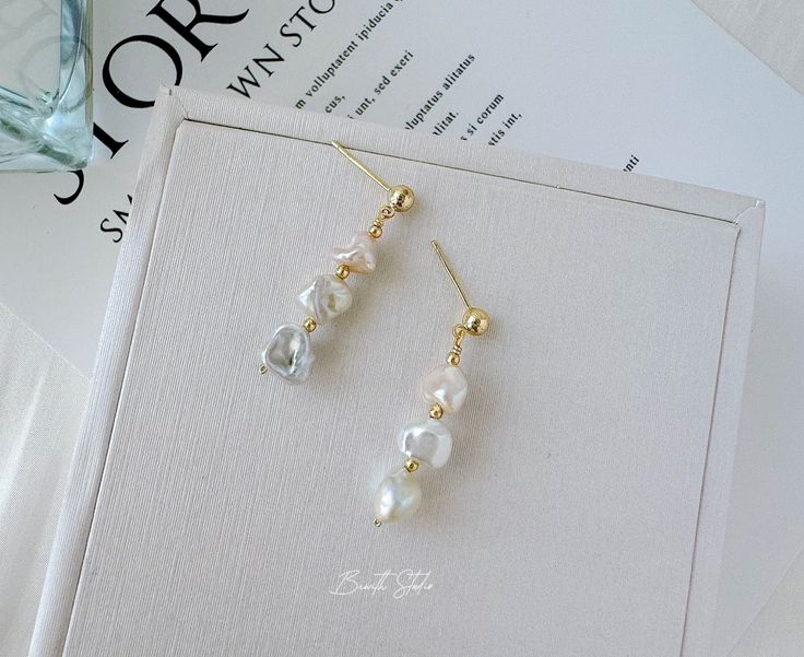 This is a very elegant pair of earrings, suitable for any occasion. The natural freshwater pearls are very lustrous.   P E A R L ∙ E A R R I N G S ✨Total Length : about 1.38 inches ✨ Pearl Size: between 7-10mm ✨Color: natural untreated, metallic white with tint of pink/ blue overtone (The color of this sheen may vary） ✨Material: Ear studs are gold plated S925 sterling silver, suitable for sensitive skin.  It is nickel free, hypoallergenic, tarnish resistant O T H E R ∙ I N F O R M A T I O N ✨ Our pieces are made with care and attention to details. ✨Freshwater pearls are entirely natural, which means that each one has its own distinct size and shape. I'll take care to ensure that the pearls harmonize beautifully with each other. ✨ This earrings  typically takes 1-3 days to process.  ✨ Your Elegant High Luster Pearl Earrings Gift, Baroque Pearl Drop Earrings As Gift, High Luster Drop Pearl Earrings For Gift, Minimalist Baroque Pearl Earrings For Gift, Dainty White Baroque Pearl Earrings, Single Dangle Baroque Pearl Earring, 14k Gold-filled Dangle Earrings With Pearl Charm, Hypoallergenic 14k Gold-filled Dangle Pearl Earrings, 14k Gold-filled Pearl White Earrings With Pearl Charm