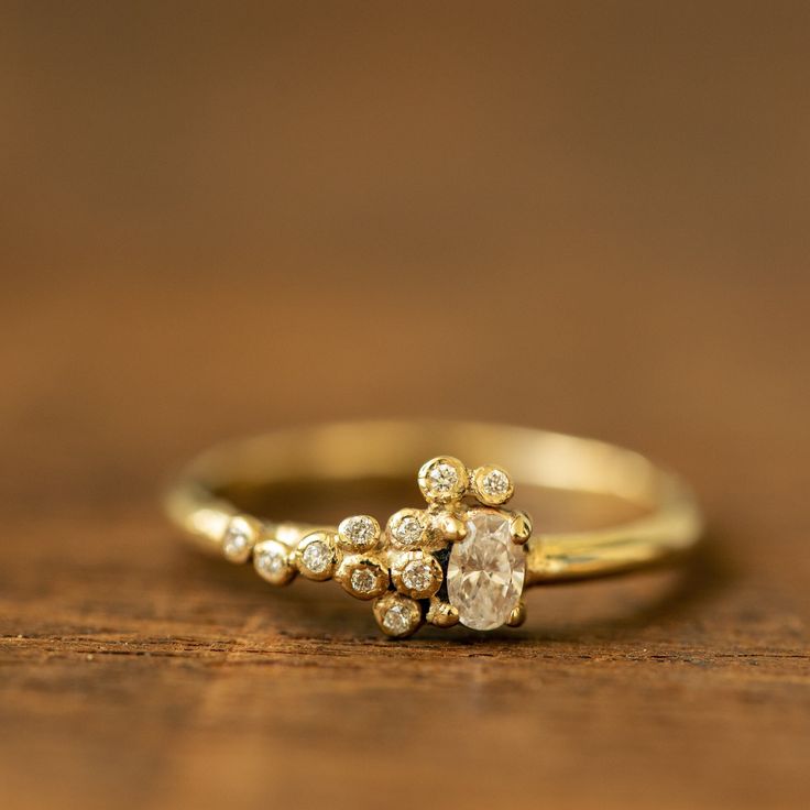 a diamond ring sitting on top of a wooden table