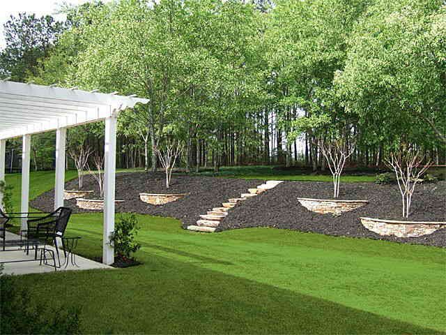 an outdoor patio and landscaping area with white pergolated roofing, chairs and tables