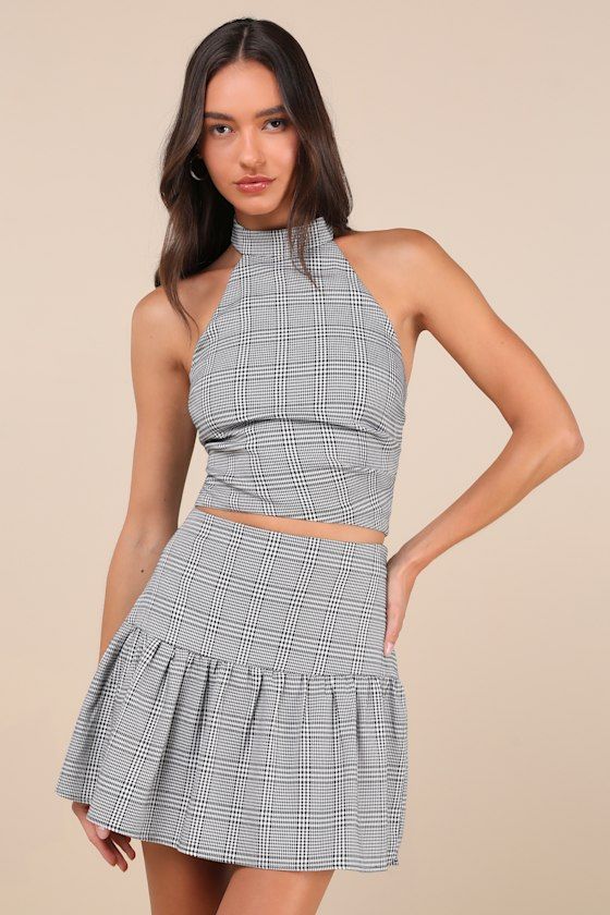 Compose a look that's sure to get you endless compliments with the Lulus Trendy Momentum Black and White Plaid Mini Skirt! Lightweight woven fabric boasts a plaid, houndstooth-style pattern as it shapes this cute skirt that has a high waist and a ruffled, lightly flaring panel that falls to a mini hem. Hidden zipper/clasp at side. Pair with the matching top for a complete look! Fit: This garment fits true to size. Length: Mid-thigh. Size medium measures 16.5" from waist to hem. Waist: Fitted - v Fitted Plaid Mini Skirt For Spring, Fitted Gingham Mini Skirt, Spring Fitted Plaid Skort, Chic Fitted Plaid Skirt, Chic Fitted Houndstooth Skirt, Fitted Mini Skirt With Houndstooth Pattern, Fitted Plaid Skirt For Party, Fitted Houndstooth Mini Skirt, Fitted Gingham Skirt With Lining