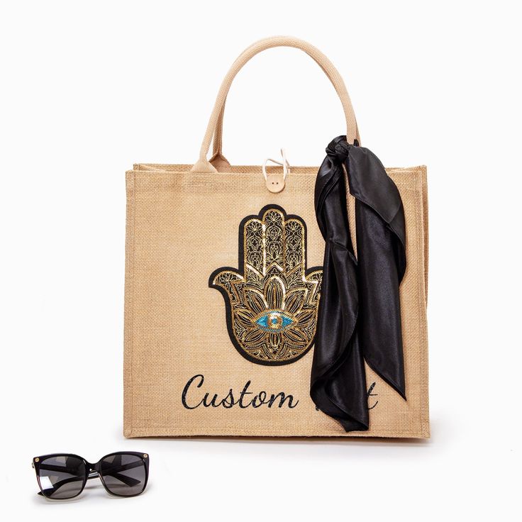 a handbag with a black scarf and sunglasses on the side, next to it is a pair of glasses