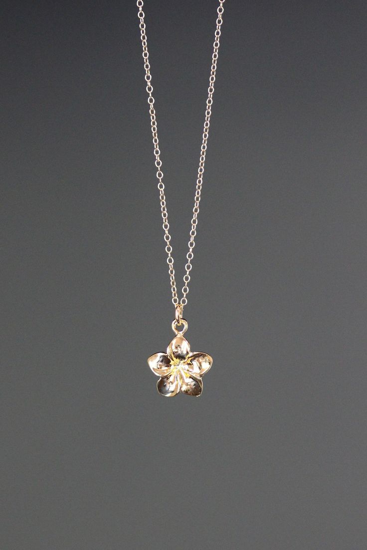 "A sweet and delicate 18k gold vermeil Plumeria flower charm simply dangles from a 14k gold filled chain. Choose from a 1mm 14k gold filled chain with a gold spring ring clasp, or a 1.5mm 14k gold filled chain with a gold lobster clasp. Each chain measures 16\" with an extension to 18\".  Please send a message if a different length chain is desired. This small and lightweight go-with-everything necklace completes any outfit for daytime or evening.   Gold flower charm: 12x11mm Total length of cha Plumeria Flower Necklace, Delicate Tiny Gold Jewelry, Everyday Flower Necklace With Flower Charm, Everyday Flower Charm Necklace, Delicate Everyday Flower Pendant Jewelry, Delicate Flower Pendant Jewelry For Everyday, Everyday Delicate Flower Pendant Jewelry, Everyday Flower Charm Jewelry, Gold Flower Shaped Necklace For Everyday