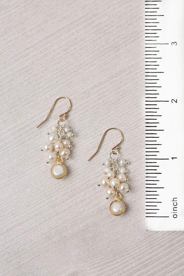 Experience the beauty and craftsmanship of the Seaside Collection with these gorgeous handmade earrings. Mixed Metal (lead and nickel free) Pearl 1.5", with gold filled ear wires We hand select our natural materials, thus there may be slight variations in color and/or size that will not detract from the overall aesthetic Our unique handcrafted designer jewelry for women is made in America, with each design created individually in our personal design studio in Floyd VA USA Handmade Dangle Pearl Earrings In 14k Gold Filled, Handmade 14k Gold-filled Dangle Pearl Earrings, Handmade 14k Gold Filled Dangle Pearl Earrings, Elegant Wire Wrapped Chandelier Earrings, Adjustable Gold Pearl Earrings With Ear Wire, Adjustable Pearl Earrings With Ear Wire, Gold Cluster Earrings For Celebrations, 14k Gold Filled Dangle Pearl Earrings For Anniversary, Handmade Delicate Drop Pearl Earrings