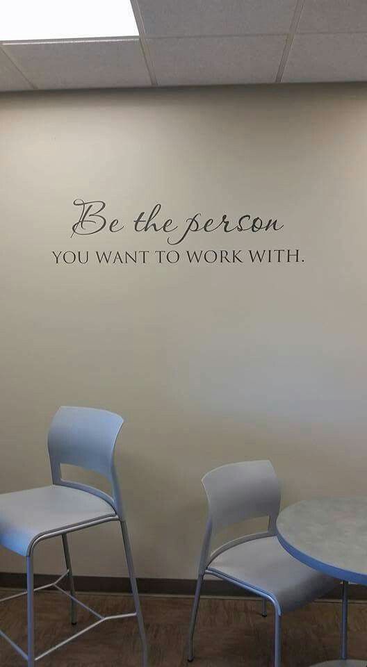 two chairs and a table in front of a wall that says be the person you want to work with