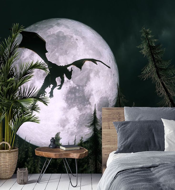 a bed room with a large wall mural and a night time scene on the wall