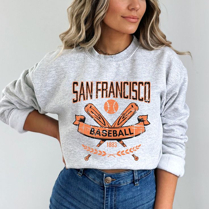 Our San Francisco Baseball Apparel is the perfect way to cheer on the home team this season. Ideal for game day, tailgates or everyday wear. Makes a great gift for any fan. SHIRT DETAILS Bella Canvas Unisex - Solid colors: 100% Cotton. - Heather colors: 52% Cotton + 48% Polyester - Runs true to size. (For looser or oversized fit consider going up a size or 2. See photos for size chart.) SWEATSHIRT & HOODIE DETAILS Gildan Heavy Blend Unisex - 50% Cotton + 50 Polyester - Runs true to size. (For looser or oversized fit consider going up a size or 2. See photos for size chart.) CARE INSTRUCTIONS Do not dryclean; Machine wash: cold (max 30C or 90F); Non-chlorine: bleach as needed; Tumble dry: low heat; Iron, steam or dry: medium heat. Wash, dry and iron inside out. MORE DESIGNS AVAILABLE https: Athletic Heather Long Sleeve T-shirt With Letter Print, Team Spirit Hoodie For Sports Season, Collegiate Sports Hoodie Tops, Fall Sports T-shirt With Letter Print, Fan Apparel Hoodie For Sports Events, Sports Hoodie Sweatshirt With Letter Print, Sports Letter Print Hoodie Sweatshirt, Fleece Tops With Letter Print For Fans, Sporty Fleece Sweatshirt For Fans