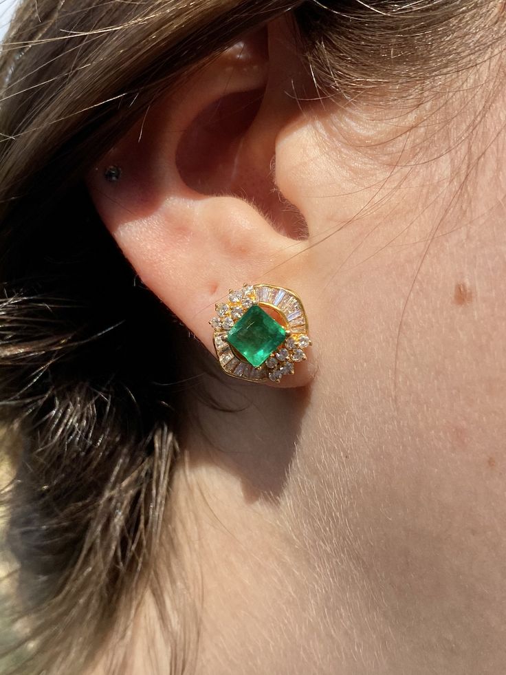 "Pacific Jewelry Presents, Vintage natural Colombian Emeralds, featuring two exquisite square cut Emeralds weighing approx. 1.70 carats (total) and adorned with lively colorless natural diamonds. Diamonds are an assortment of baguette and round cut, approx. 1.35 carats (total). These beautiful earrings are mounted in 18k yellow gold, and have a safe push back closure made in 14k gold for extra strength and durability. The Emeralds are of the highest quality and are untreated. The deep \"muzo gre Luxury Gia Certified Yellow Gold Earrings, Gia Certified Luxury Yellow Gold Earrings, Gia Certified Emerald Earrings For Formal Occasions, Luxury Gia Certified Yellow Gold Diamond Earrings, Luxury Yellow Gold Cluster Earrings With Gemstones, Formal Baguette Cut Emerald Earrings, Formal Baguette-cut Emerald Earrings, Formal Yellow Gold Diamond And Emerald Earrings, Elegant Green Baguette Cut Earrings