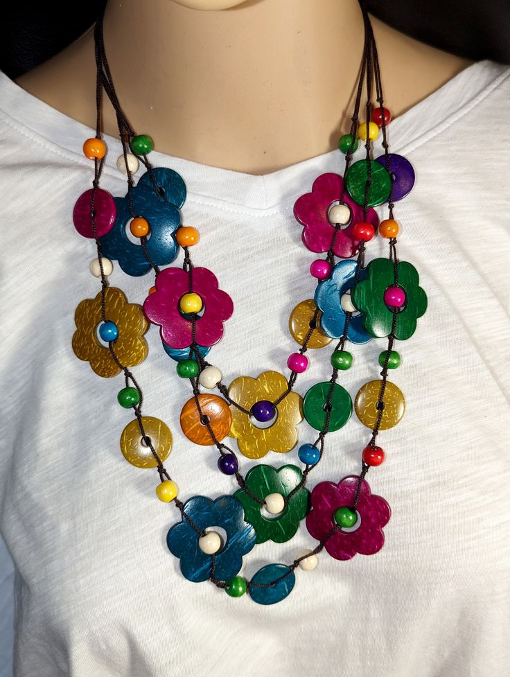 "Bright and Colorful to match most everything, this handmade Bohemian, multi layered Flower Beaded Necklace is a wardrobe must have. 30\", 15\" drop. Makes a nice gift or just for yourself. Comes in a Gift Bag." Multicolor Round Beads Flower Necklace For Summer, Multicolor Fair Trade Beads For Festival, Bohemian Multicolor Flower Necklace For Summer, Multicolor Festival Beads, Multicolor Flower Necklace For Summer Beach, Beaded Multicolor Flower Necklace For Beach, Artisan Multicolor Wooden Beaded Necklaces, Artisan Multicolor Wooden Beads Necklace, Colorful Beaded Flower Necklace For The Beach